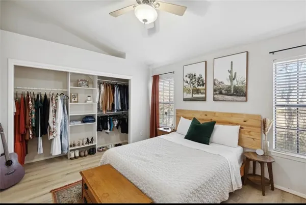 a bedroom with a large bed and a chandelier