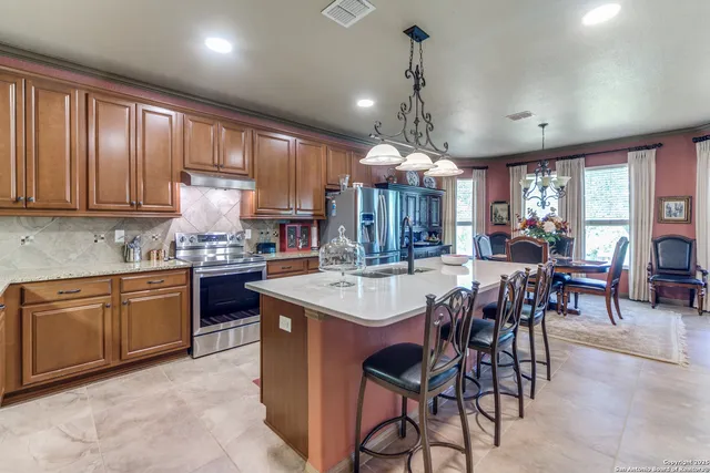 a dining room with furniture a chandelier and wooden floor