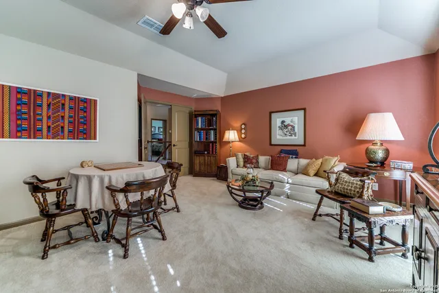 a living room with furniture a rug and a flat screen tv