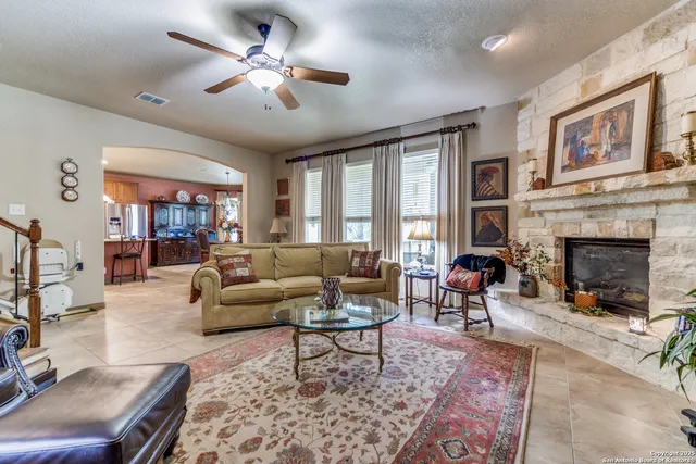 a living room with furniture a rug and a bookshelf