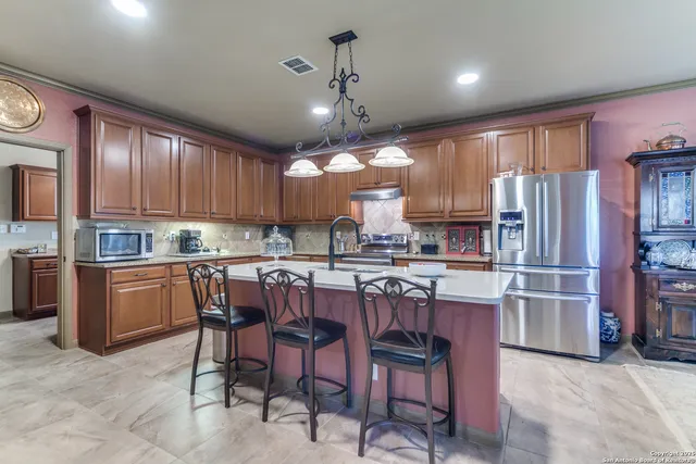 a kitchen with kitchen island granite countertop lots of counter top space