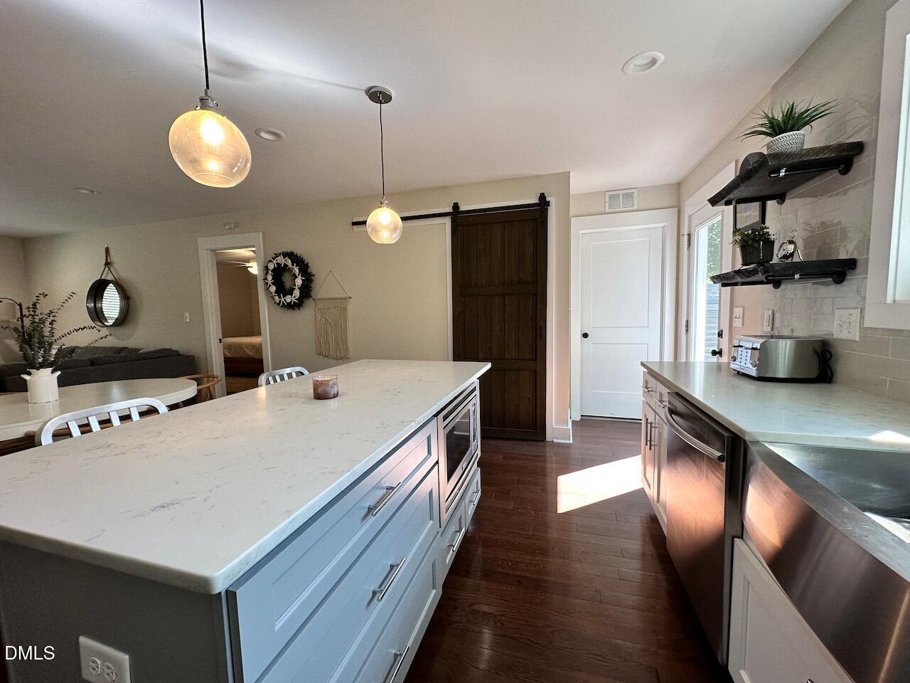 1006 East Martin Street Raleigh, NC 27601 - Photo 11 of 22 a kitchen with stainless steel appliances a sink stove and refrigerator