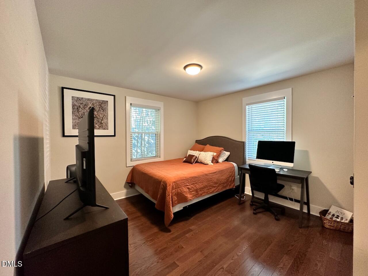 1006 East Martin Street Raleigh, NC 27601 - Photo 16 of 22 a bedroom with a bed and wooden floor