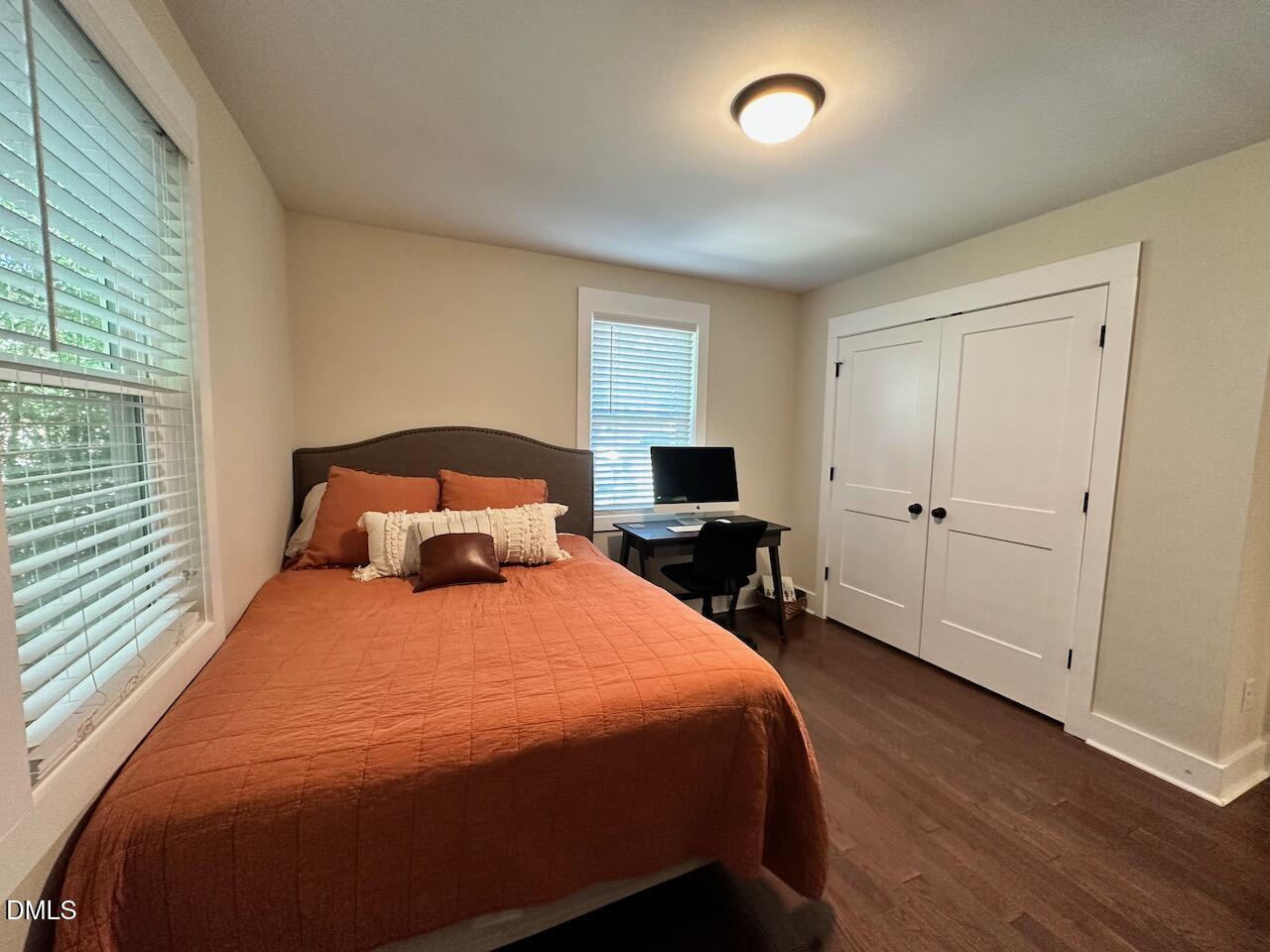 1006 East Martin Street Raleigh, NC 27601 - Photo 17 of 22 a bedroom with a bed and wooden floor