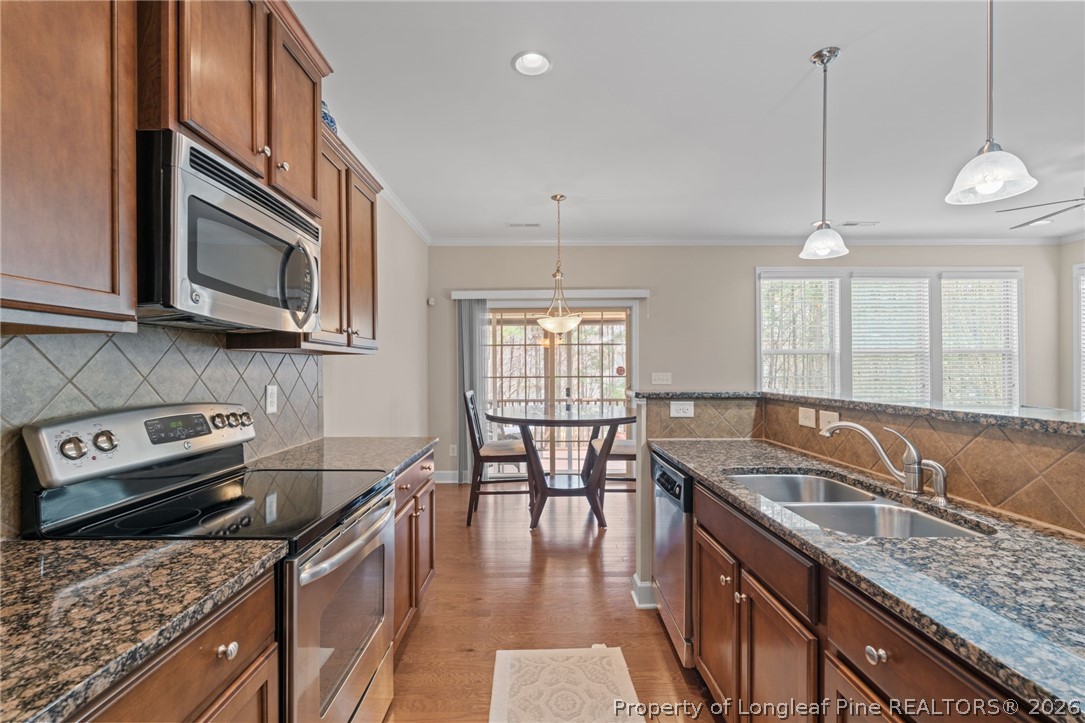126 Pine Hawk Drive Spring Lake, NC 28390 - Photo 13 of 48 a kitchen with granite countertop a sink a counter space appliances and cabinets