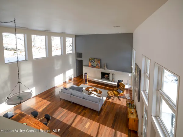 a living room filled with furniture and a floor to ceiling window