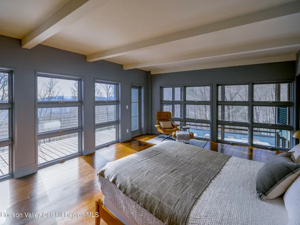 a bedroom with a bed a table and a chair