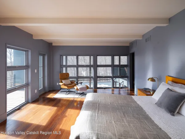 a large kitchen with a table chairs stove and wooden floor