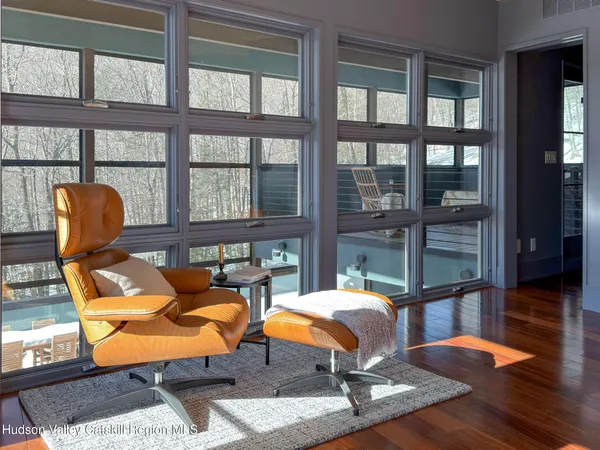 a living room with furniture and large windows
