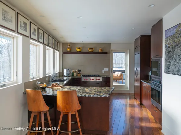 a living room with furniture a table and wooden floor