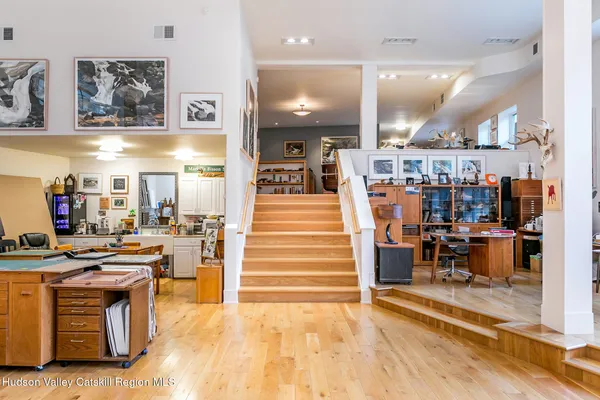 an aerial view of a house with balcony and trees