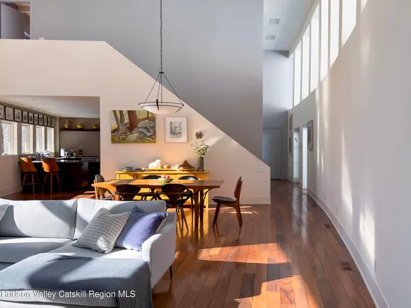 a dining room with furniture a chandelier and window