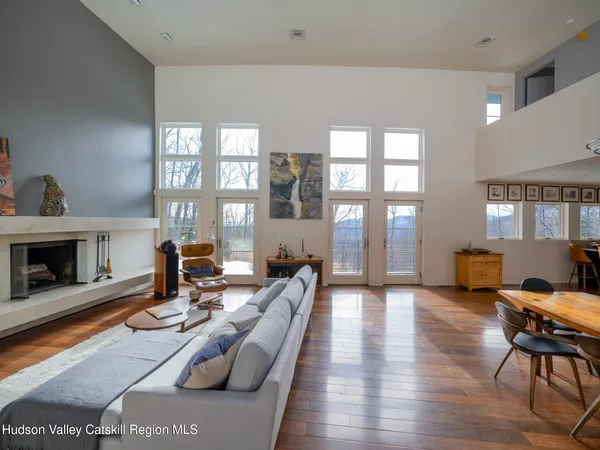 a view of a livingroom with workspace and a window