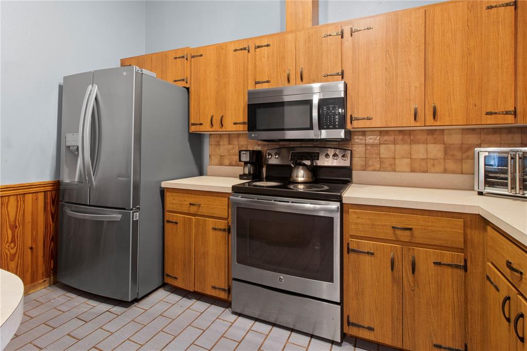 1143 Meyers Road Venice, FL 34292 - Photo 12 of 59 a kitchen with a refrigerator stove and microwave