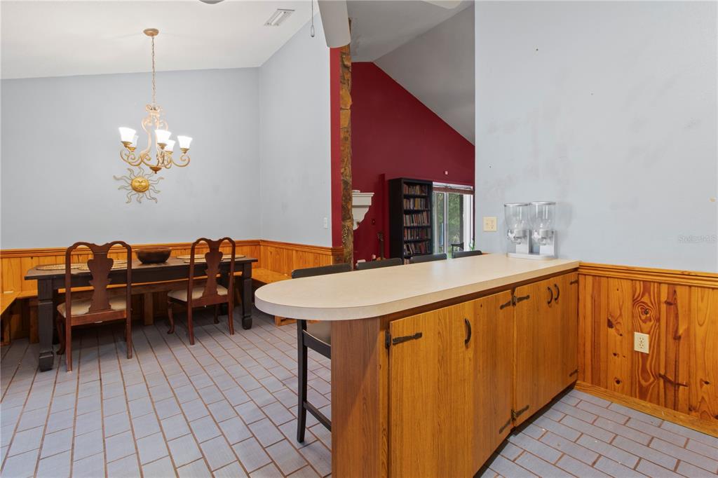 1143 Meyers Road Venice, FL 34292 - Photo 13 of 59 a dining room with a table chairs and a kitchen view