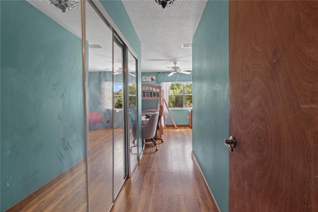 1143 Meyers Road Venice, FL 34292 - Photo 19 of 59 a view of a hallway with wooden floor and staircase