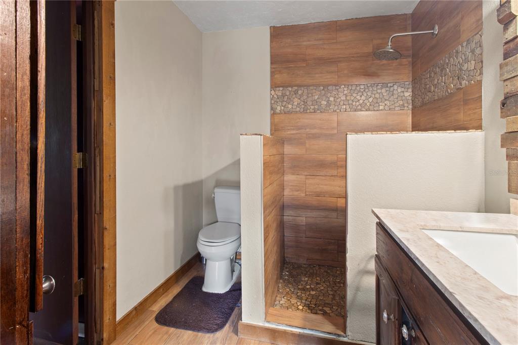 1143 Meyers Road Venice, FL 34292 - Photo 21 of 59 a bathroom with a granite countertop toilet and a sink