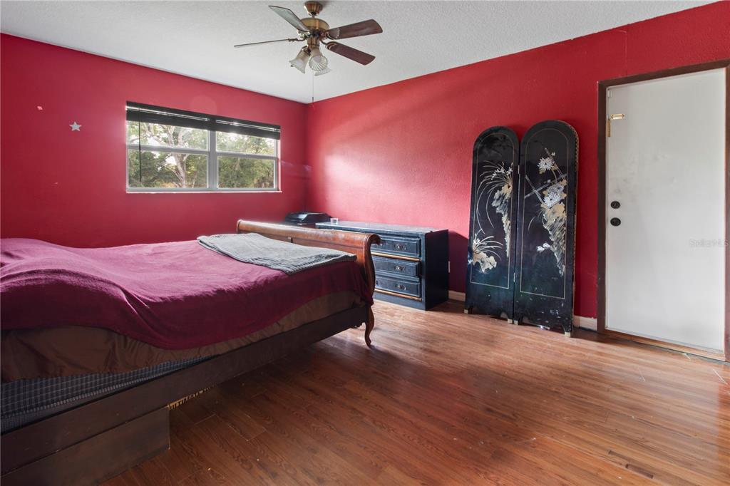 1143 Meyers Road Venice, FL 34292 - Photo 23 of 59 a bedroom with a bed and a chandelier