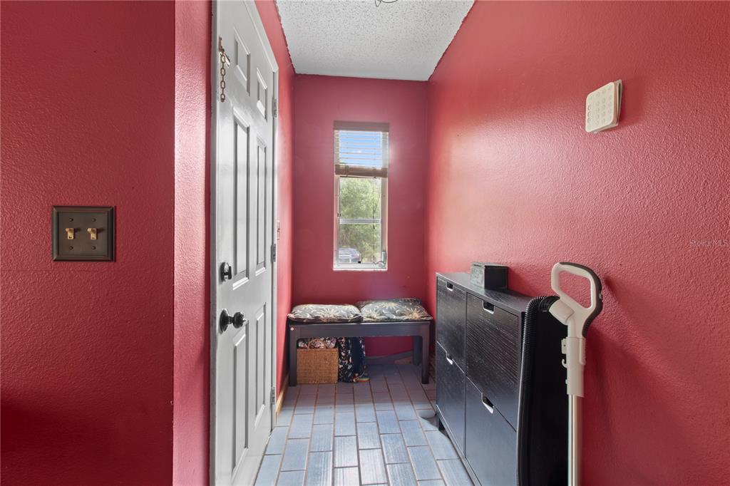1143 Meyers Road Venice, FL 34292 - Photo 3 of 59 a view of a hallway with workspace and a couch