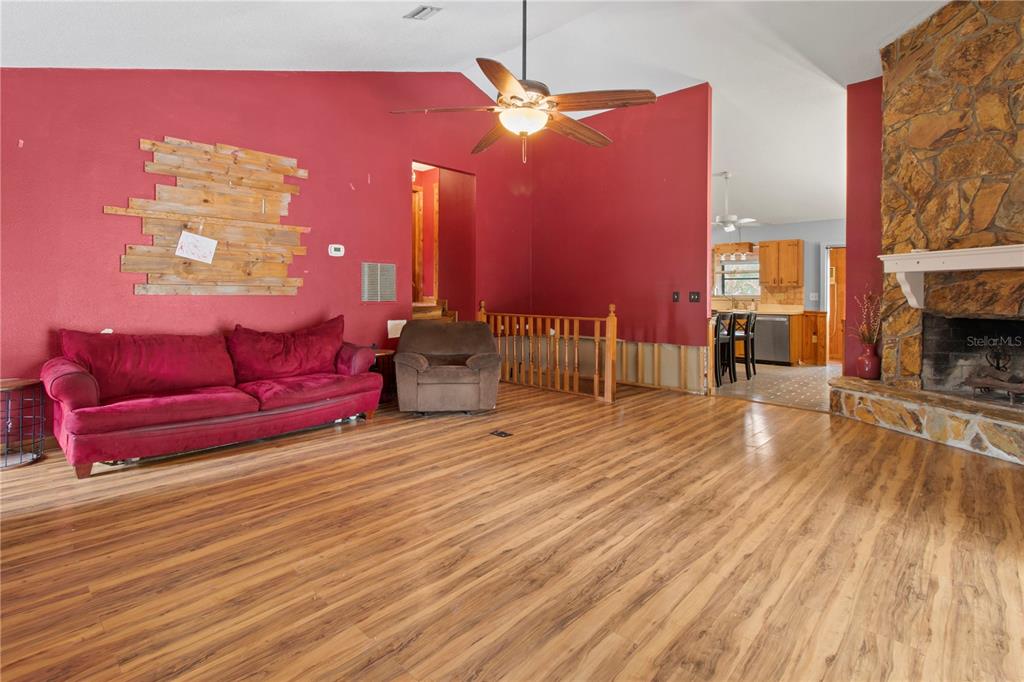 1143 Meyers Road Venice, FL 34292 - Photo 4 of 59 a living room with furniture fireplace and wooden floor