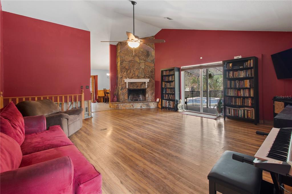 1143 Meyers Road Venice, FL 34292 - Photo 5 of 59 a living room with furniture a fireplace and a flat screen tv