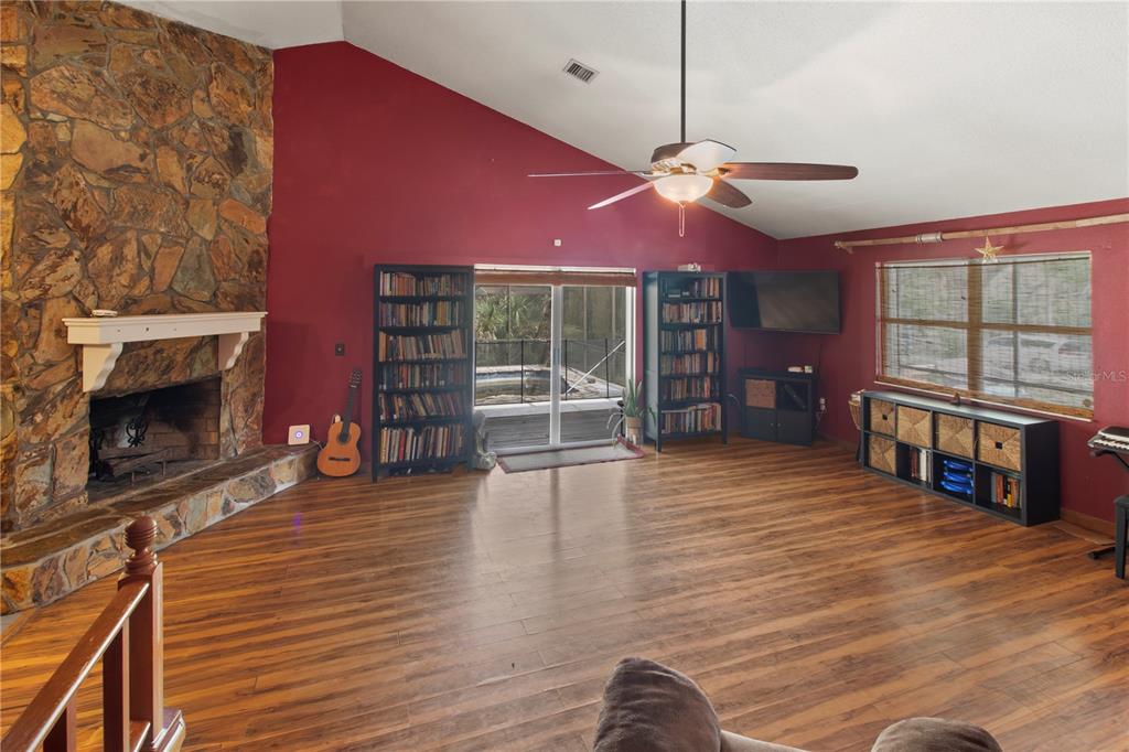 1143 Meyers Road Venice, FL 34292 - Photo 7 of 59 a living room with fireplace furniture and a wooden floor