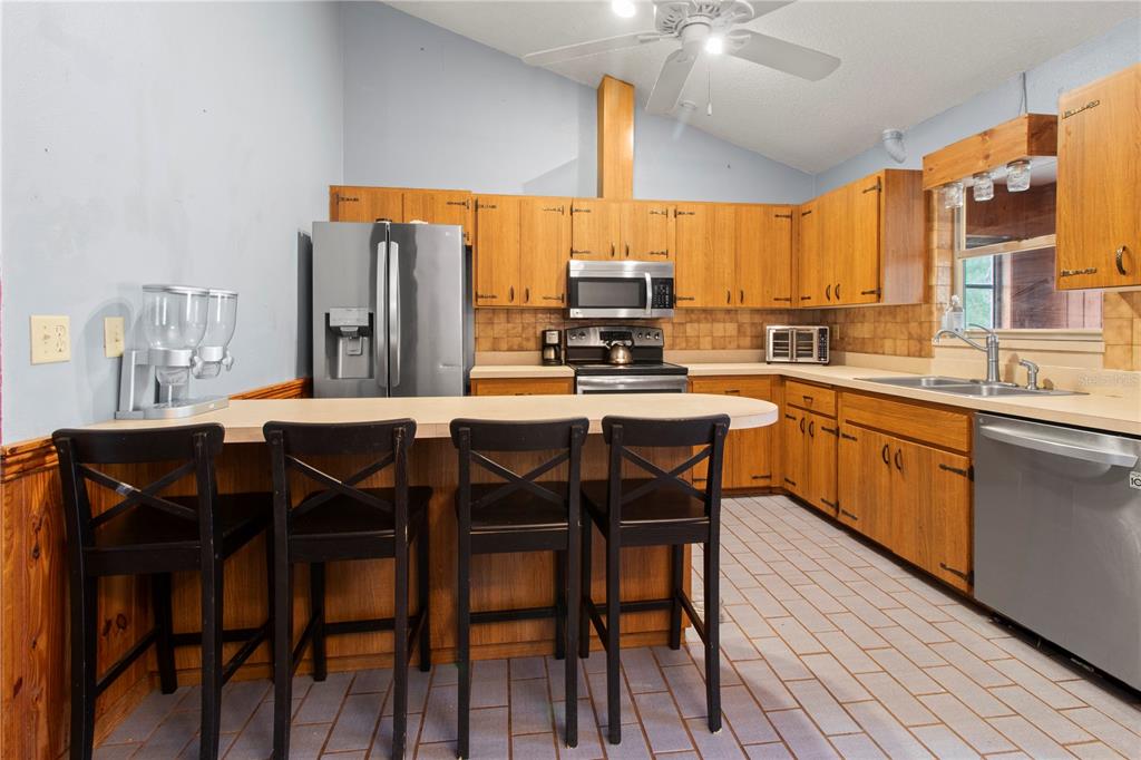 1143 Meyers Road Venice, FL 34292 - Photo 10 of 59 a kitchen with a table chairs sink and cabinets