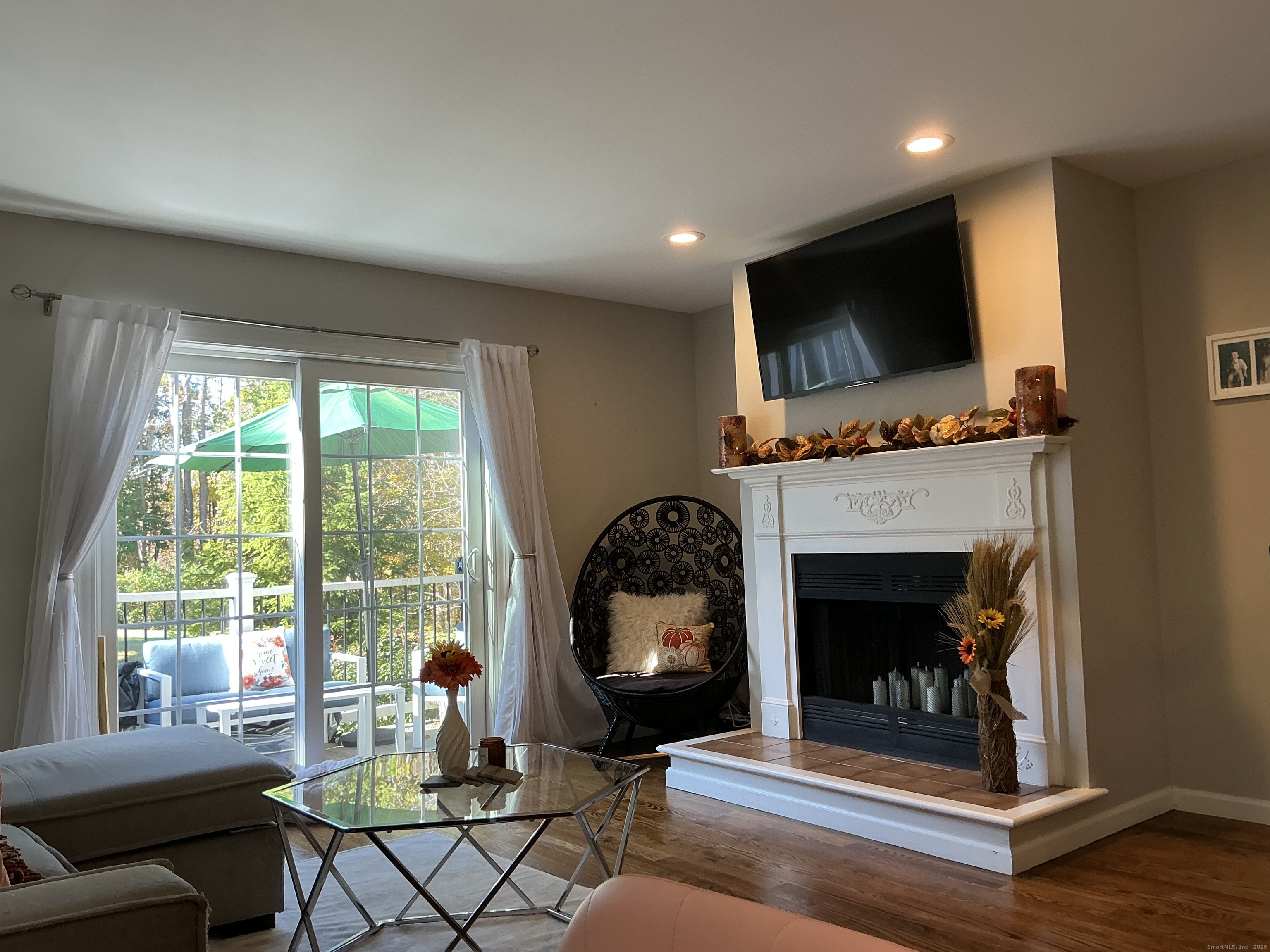 751 Long Hill Road, Unit D Middletown, CT 06457 - Photo 11 of 28 a living room with furniture a fireplace and a flat screen tv