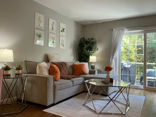 a living room with furniture and a large window