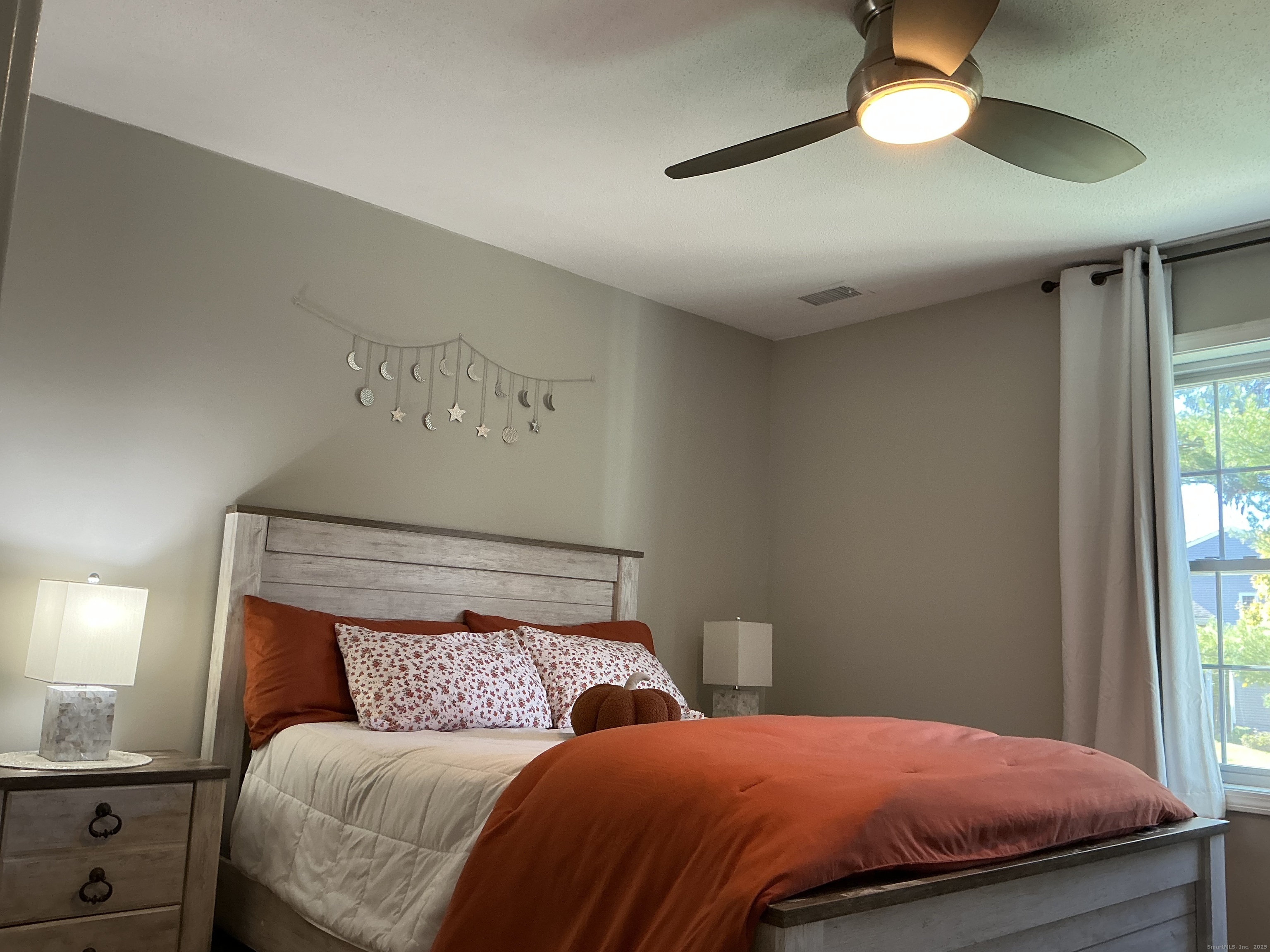 751 Long Hill Road, Unit D Middletown, CT 06457 - Photo 13 of 28 a bedroom with a bed and a chandelier