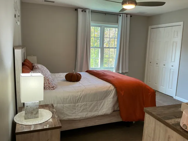 a bedroom with a bed and dresser