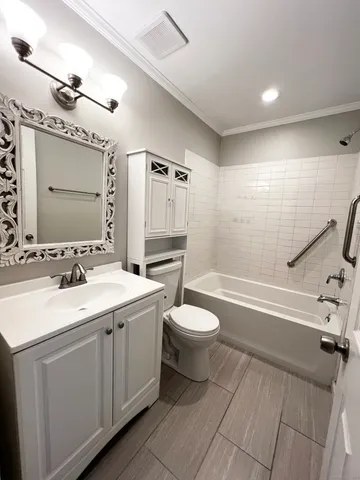 a bathroom with a double vanity sink toilet mirror and bathtub