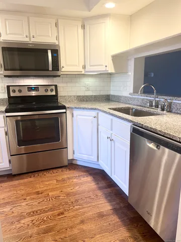 a kitchen with granite countertop a stove and a sink