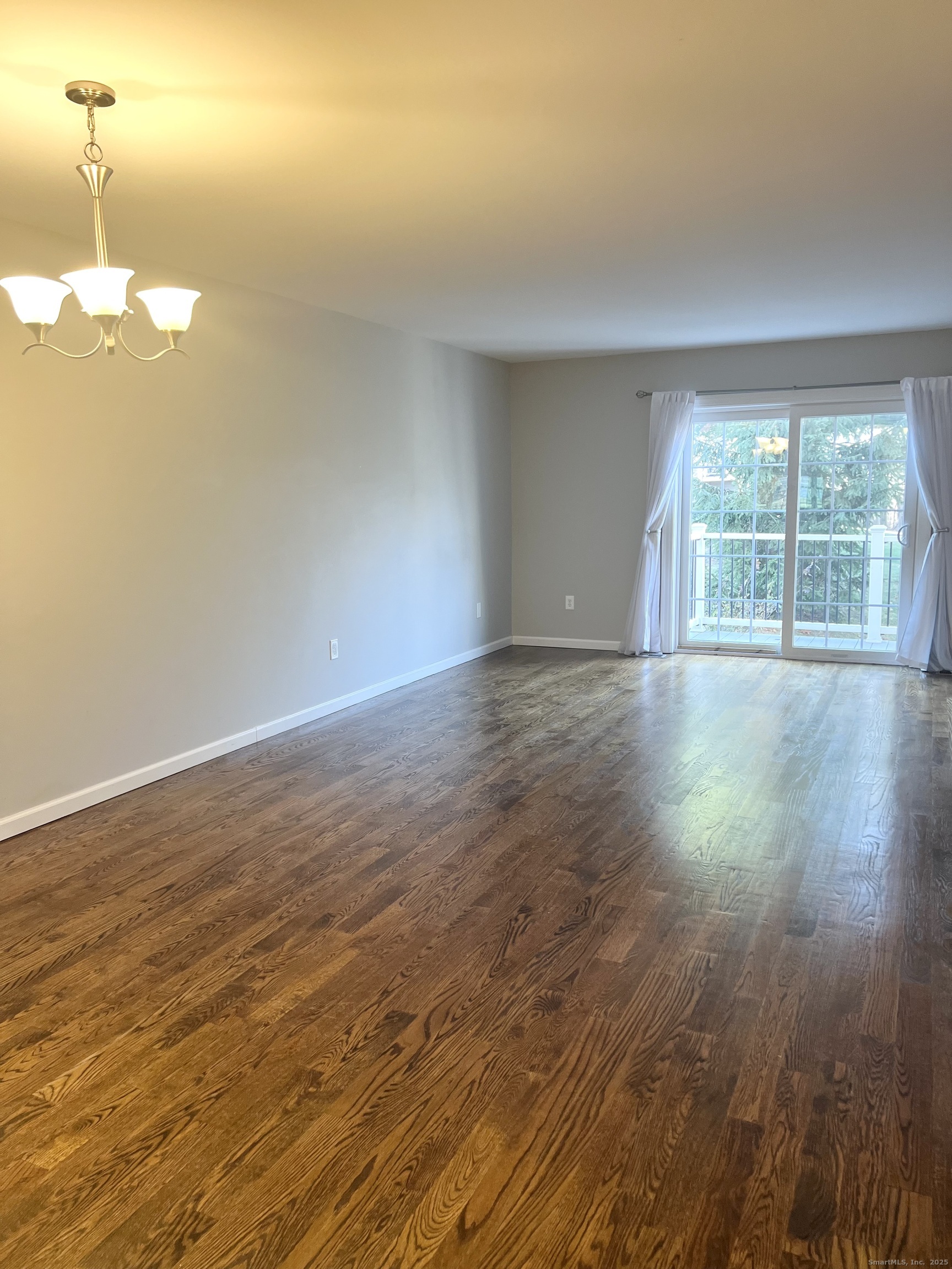751 Long Hill Road, Unit D Middletown, CT 06457 - Photo 6 of 28 a view of empty room with wooden floor and fan