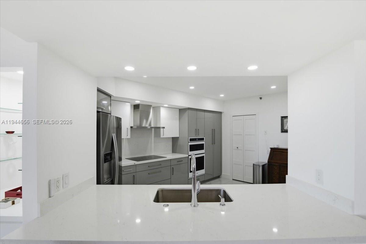 8925 Collins Avenue, Unit 9F Surfside, FL 33154 - Photo 11 of 73 a kitchen with stainless steel appliances refrigerator and microwave