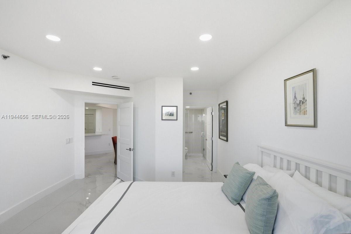 8925 Collins Avenue, Unit 9F Surfside, FL 33154 - Photo 22 of 73 a bedroom with a bed and bathroom