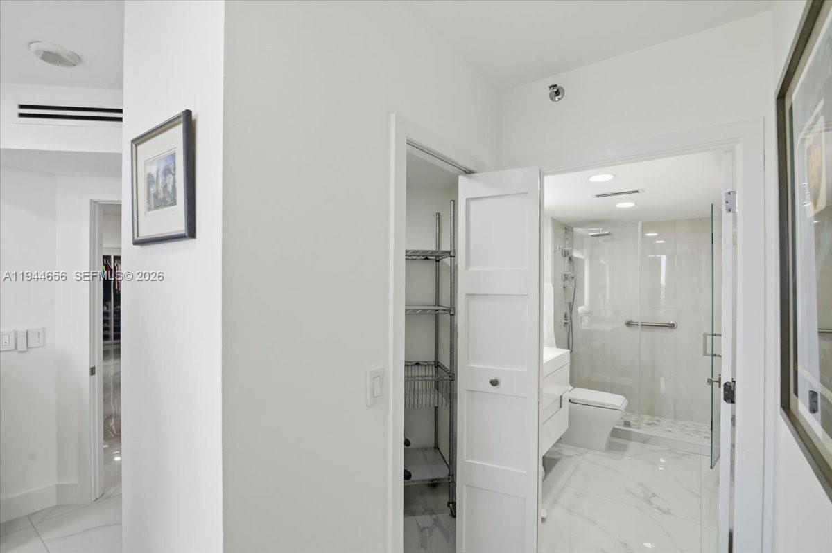 8925 Collins Avenue, Unit 9F Surfside, FL 33154 - Photo 23 of 73 a bathroom with a glass door shower
