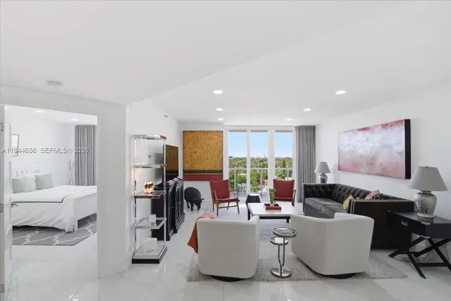 a very nice looking living room with furniture and a large window