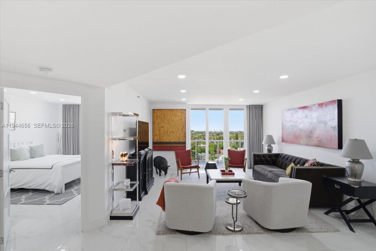 8925 Collins Avenue, Unit 9F Surfside, FL 33154 - Photo 36 of 73 a living room with furniture and a flat screen tv