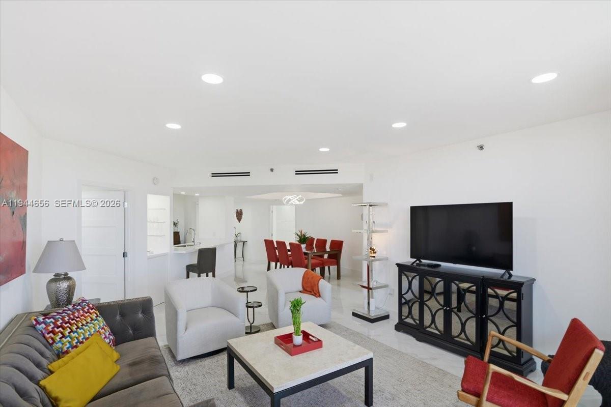 8925 Collins Avenue, Unit 9F Surfside, FL 33154 - Photo 39 of 73 a living room with furniture and a flat screen tv