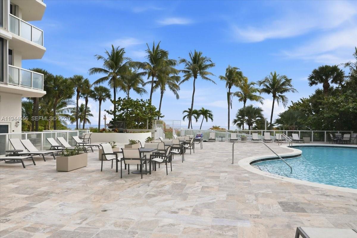 8925 Collins Avenue, Unit 9F Surfside, FL 33154 - Photo 46 of 73 a view of a swimming pool and lounge chair