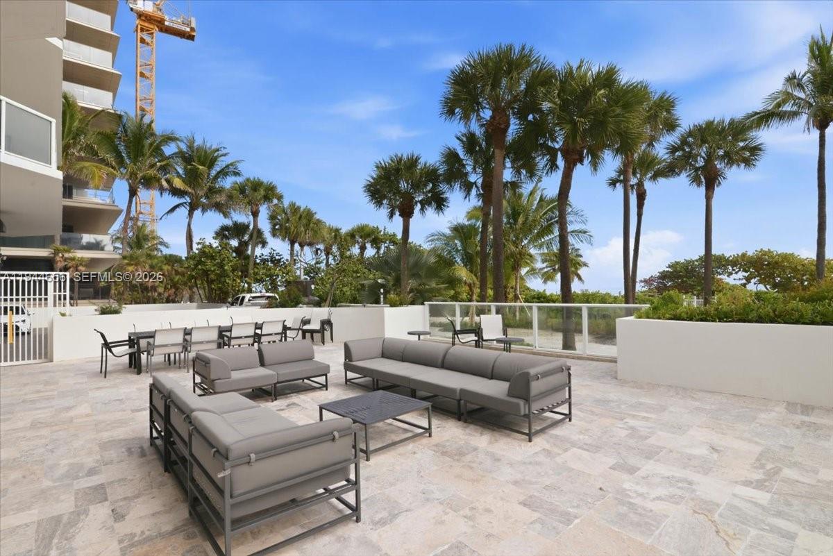 8925 Collins Avenue, Unit 9F Surfside, FL 33154 - Photo 49 of 73 a view of a terrace with couches and a fire pit