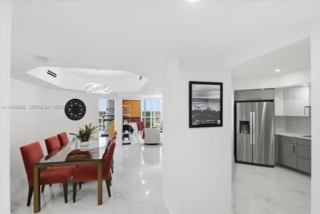 a living room with furniture and a painting on the wall
