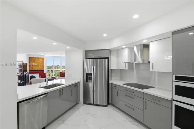 a kitchen with stainless steel appliances refrigerator and microwave
