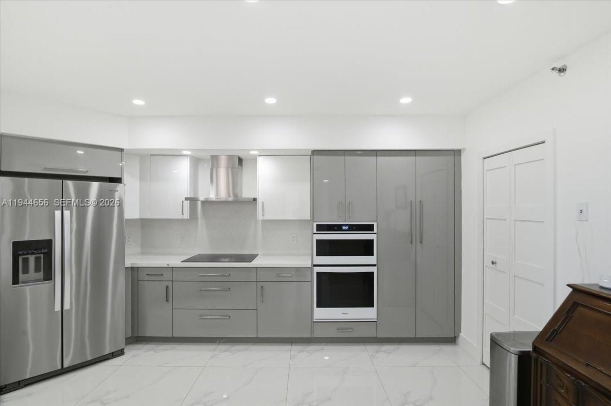 8925 Collins Avenue, Unit 9F Surfside, FL 33154 - Photo 8 of 73 a kitchen with stainless steel appliances a refrigerator sink and stove