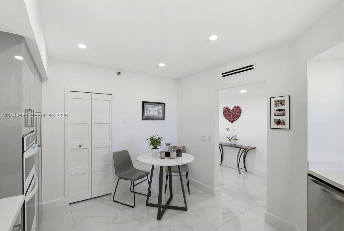 8925 Collins Avenue, Unit 9F Surfside, FL 33154 - Photo 10 of 73 a view of a dining room with furniture and a chandelier fan