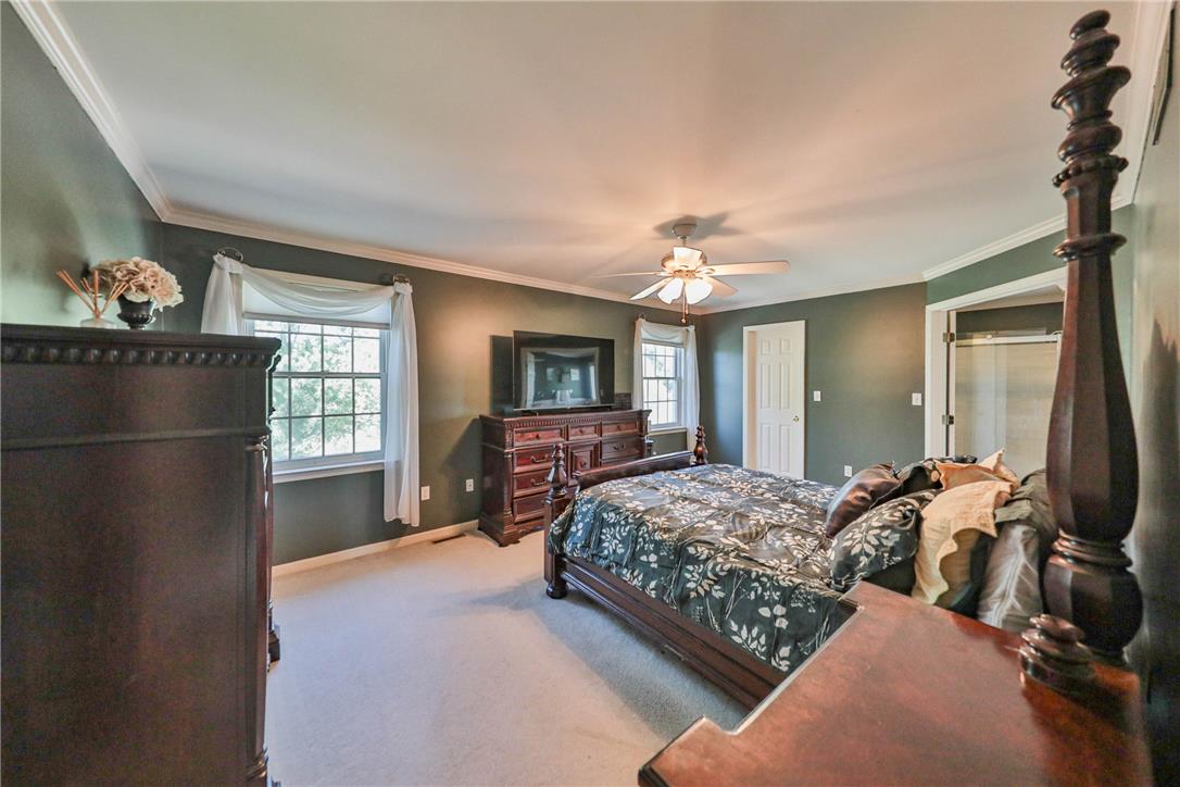 63 Long Road Lenhartsville, PA 19534 - Photo 85 of 100 Crown molding and soft carpeting enhance this bedroom with its adjacent private bath.