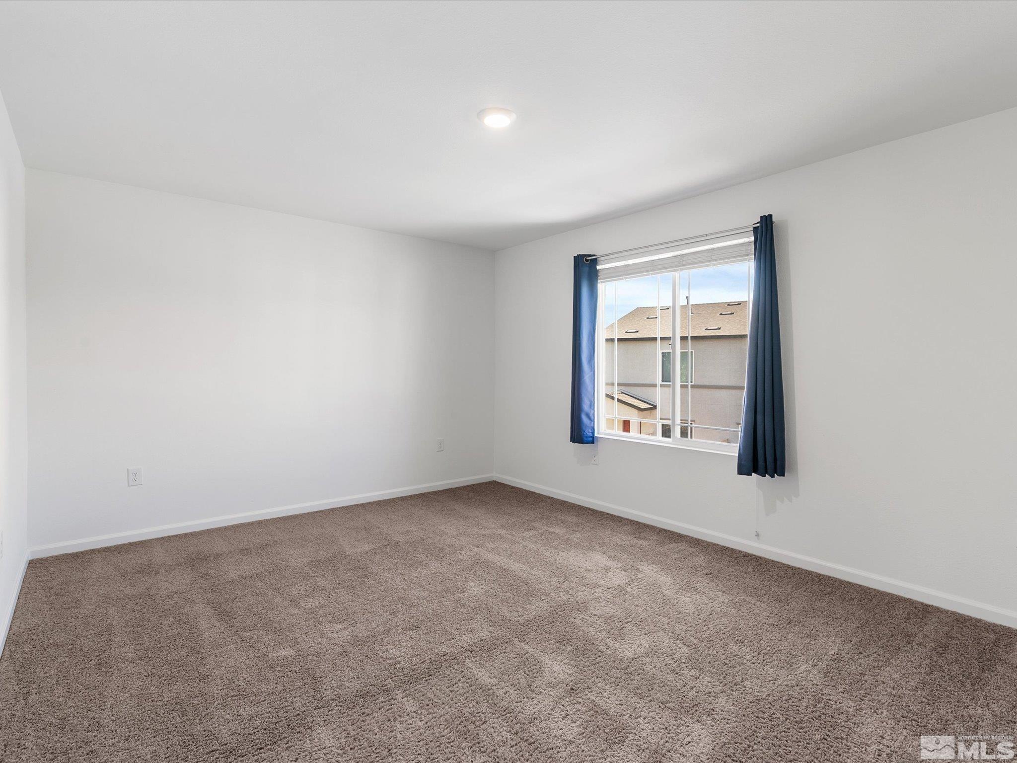 405 Autumn Breeze Circle Reno, NV 89511 - Photo 17 of 28 an empty room with windows