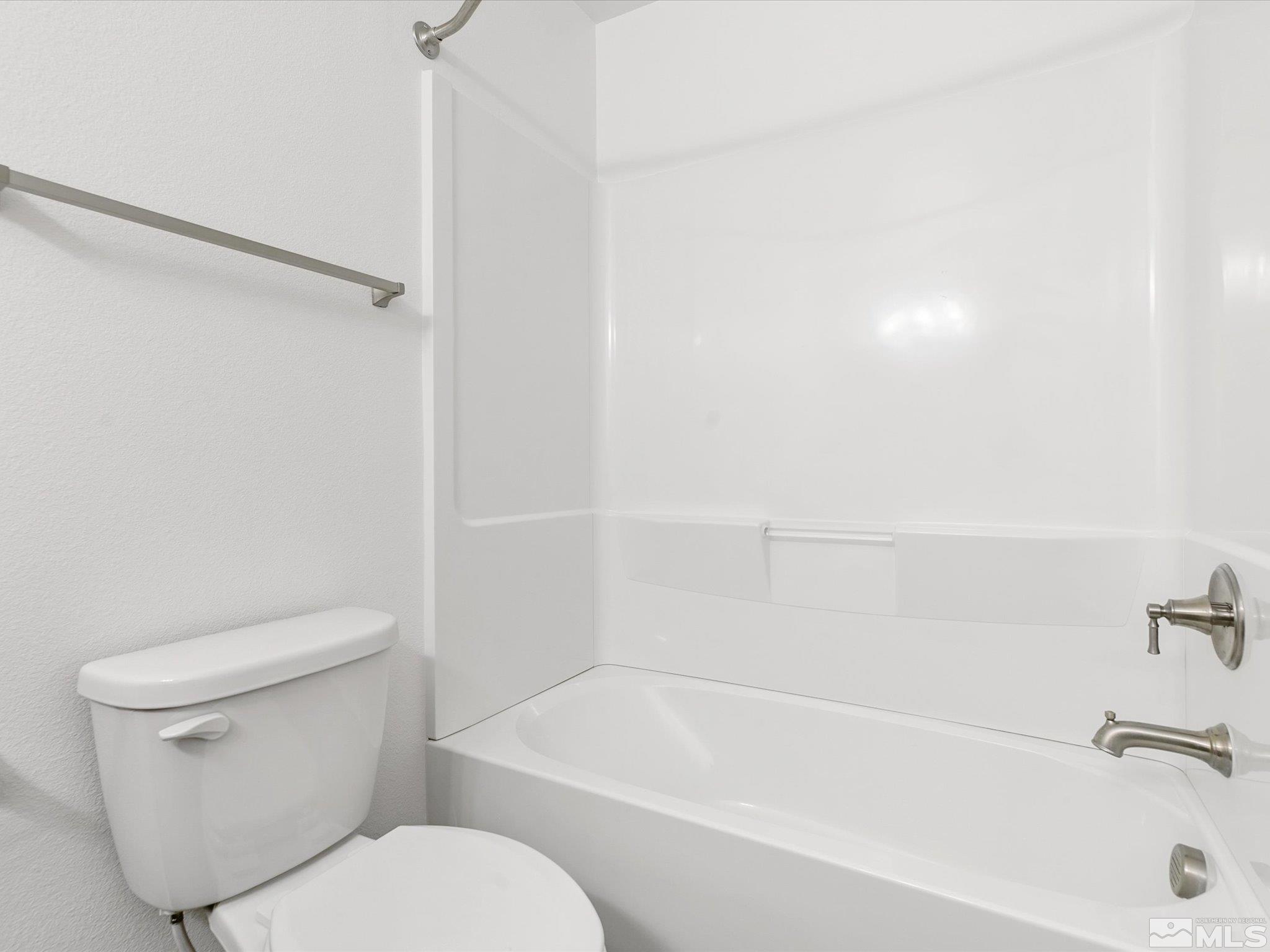 405 Autumn Breeze Circle Reno, NV 89511 - Photo 26 of 28 a white toilet sitting next to a bath tub