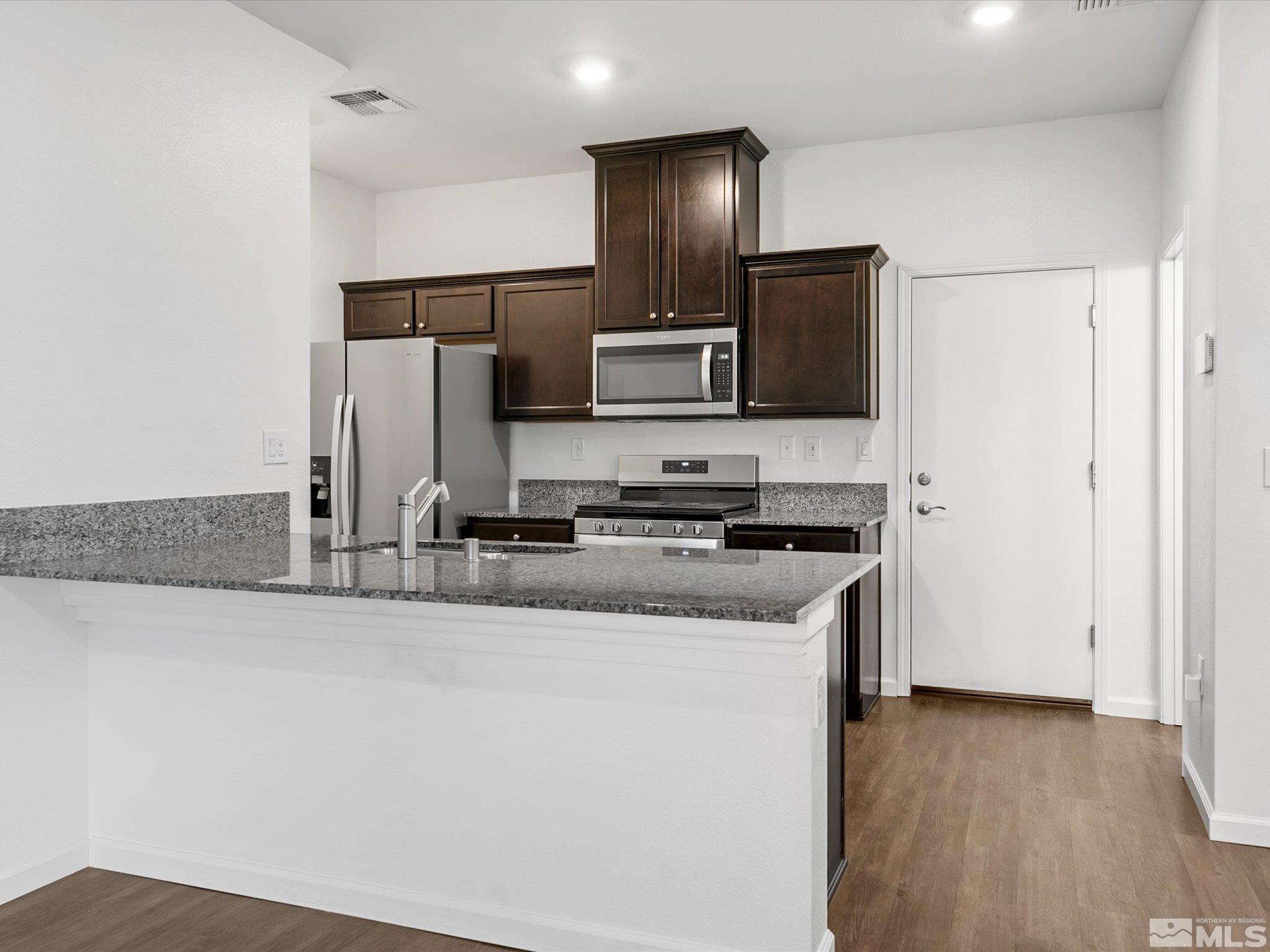 405 Autumn Breeze Circle Reno, NV 89511 - Photo 10 of 28 a kitchen with stainless steel appliances granite countertop a refrigerator and a stove